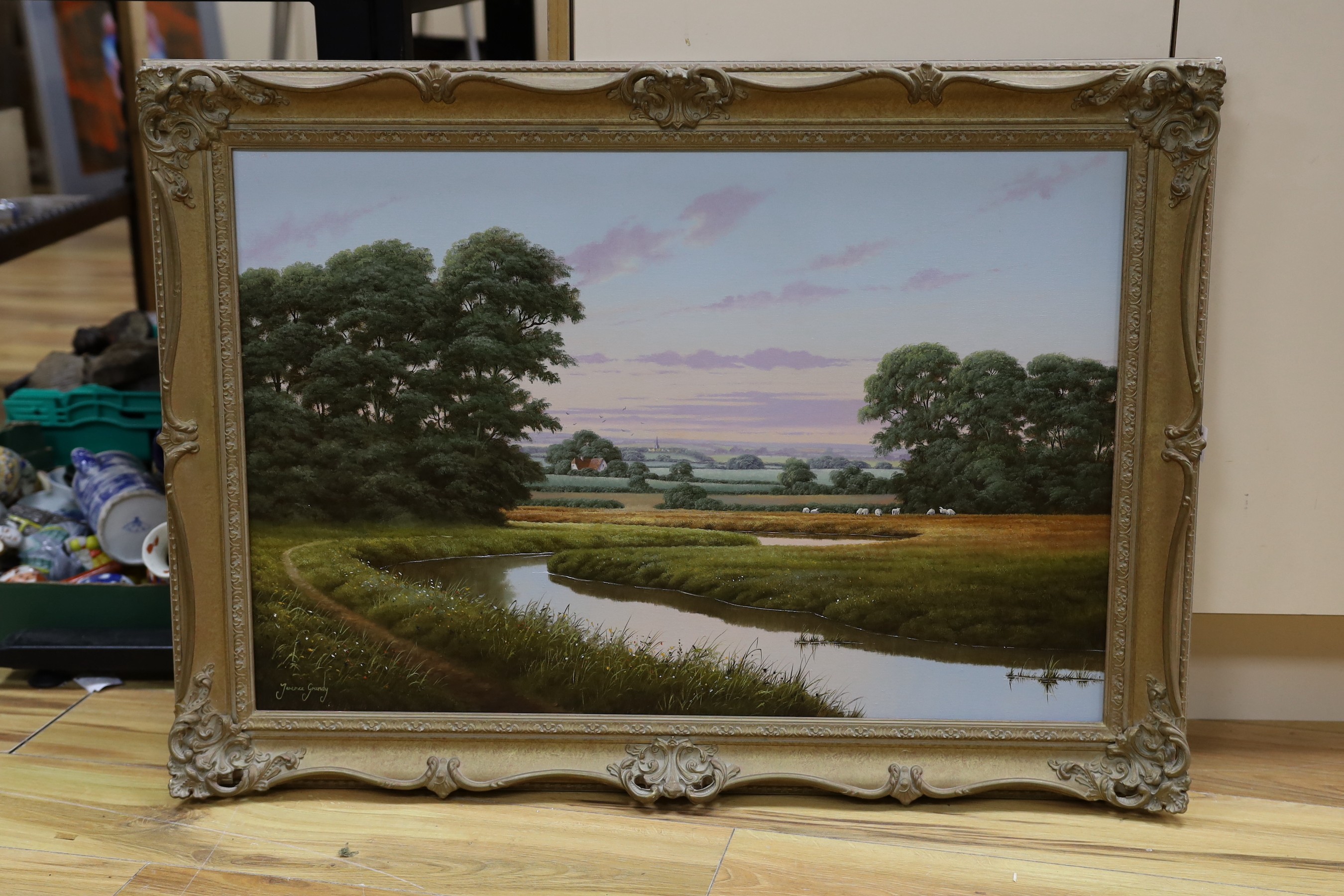 Terence Grundy (b.1956), oil on canvas, River landscape with sheep in pasture, signed, 50 x 75cm